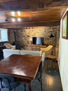 a dining room with a wooden table and chairs at Casa D Matilde in Góis