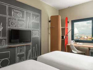 a bedroom with a chalkboard wall with a tv at Ibis Istanbul Tuzla in Tuzla +119 photos