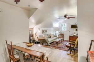 a living room with a table and a couch at Walk to Downtown Chico! Tree-Lined Apt w/ Deck in Chico