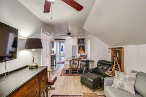 a living room with a couch and a table at Walk to Downtown Chico! Tree-Lined Apt w/ Deck in Chico
