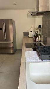 a kitchen with a stainless steel refrigerator and a counter at maisonnette in Menglon +19 photos