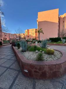 a circular garden with plants in front of a building at Al ATLAS résidence in Marrakesh