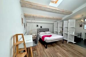 a bedroom with a bed and a desk and a table at Maison Loft atypique - Jacuzzi clim et jardin in Saint-Jean-de-Védas