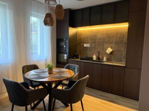 a kitchen with a table and chairs in a room at Heaven SPA Eger in Eger