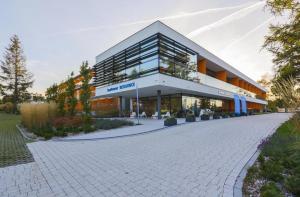 a large building with a cobblestone street in front of it at Sea Power Studio Loft in Jastrzębia Góra