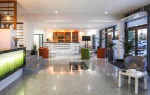 a lobby with a tv and chairs and a reception desk at Sea Power Studio Loft in Jastrzębia Góra