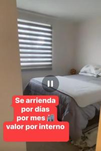 a sign that is on a bed in a room at Depto Condominio Buena Vista in Coronel