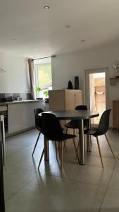 a dining room table and chairs in a kitchen at maisonnette in Menglon