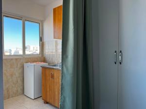 a kitchen with a window and a sink and a refrigerator at Vila Vienna in Donji Štoj