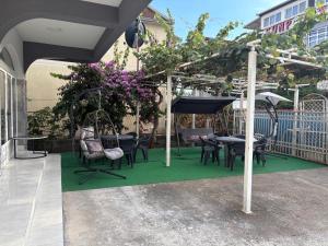 a patio with a table and chairs and an umbrella at Vila Vienna in Donji Štoj +14 photos