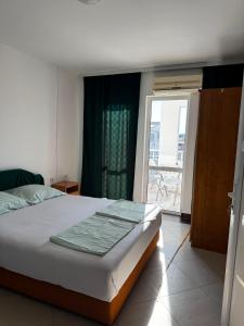 a bedroom with a bed and a large window at Vila Vienna in Donji Štoj