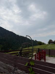 a wooden fence with a playground in a field at Mitarbi Silence - cozy holiday cottages in mountains 
