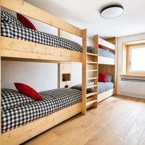 two bunk beds in a small room with at Coriva Homes - Cogolo in Cogolo