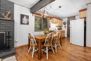 a kitchen with a wooden table and chairs at Smoke Tree Hollow AC Pine Air in Shaver Lake