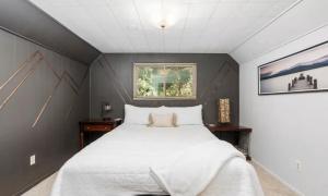 a bedroom with a large white bed and a window at Smoke Tree Hollow AC Pine Air in Shaver Lake