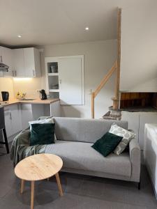a living room with a couch and a table at Le Petit Fournil d'Aywaille in Aywaille