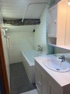 a bathroom with a sink and a bath tub at Le Petit Fournil d'Aywaille in Aywaille