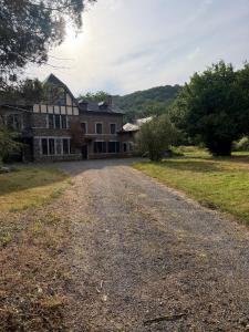 an empty road in front of a large house at Le Petit Fournil d'Aywaille in Aywaille