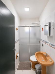 a bathroom with a shower with a toilet and a sink at Solar das Andorinhas Pousada in Itapoa +135 photos