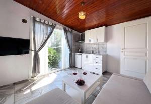 a kitchen with two glasses of wine on a table at Satsuma Butik Otel in Seferihisar