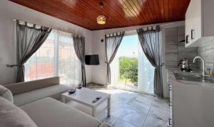 a living room with a couch and a table at Satsuma Butik Otel in Seferihisar