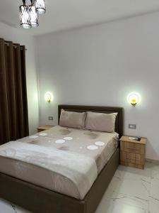 a bedroom with a large bed with two night stands at Bujtina4A Rrenc in Renc