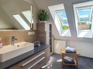 a bathroom with a sink and two skylights at Tordalk 09 in Prerow