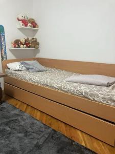 a bed with a wooden frame in a room at Nevade home in Gornji Milanovac +10 photos
