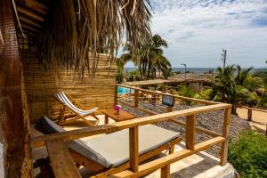 a deck with a chaise lounge and a swimming pool at Las Cabañas de Antica in Vichayito
