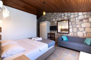 a bedroom with a large bed and a couch at Satsuma Butik Otel in Seferihisar