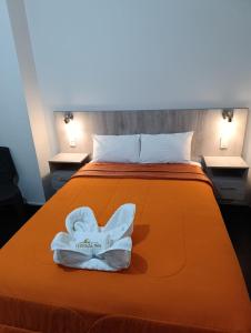 a hotel room with a bed with towels on it at HOTEL BOUTIQUE TerrazaINN in Arequipa