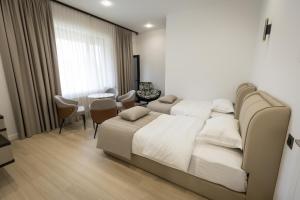 a hotel room with a bed and a table and chairs at Lchak Hotel in Yeghegnadzor