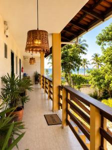 a balcony of a house with a view of the ocean at Solar das Andorinhas Pousada in Itapoa
