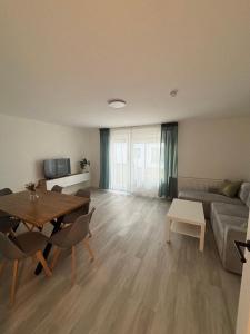 a living room with a table and a couch at AG Apartments Waiblingen in Waldmühle