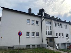 a white building with a sign in front of it at AG Apartments Waiblingen in Waldmühle