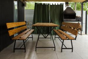 two benches and a table and a table and chairs at Villatun in Stepʼanavan