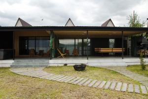 a house with a patio and a bench in front of it at Villatun in Stepʼanavan
