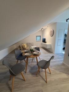 a living room with a table and chairs at AG Apartments Waiblingen in Waldmühle