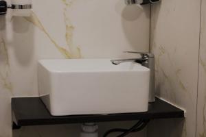 a white sink on a black shelf in a bathroom at Villatun in Stepʼanavan +26 photos