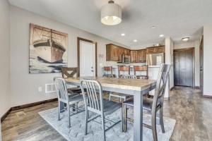 a kitchen and dining room with a table and chairs at Bridges Bay Vacation Cabin 279 in Arnolds Park