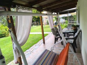 a screened in porch with a table and chairs at Maria's House in Keramoti