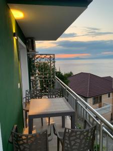 a patio with a table and chairs on a balcony at Pateriku Apartments in Shkodër
