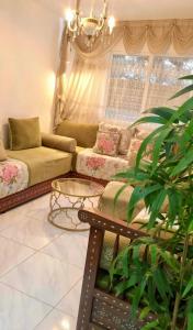 a living room with a couch and a table at Basatine in Fez
