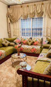 a living room with a couch and a table at Basatine in Fez