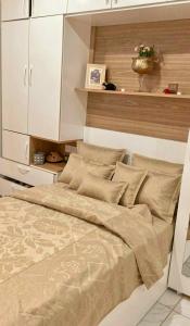 a bed in a bedroom with a white cabinet at Basatine in Fez