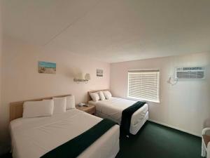 a hotel room with two beds and a window at Sea Scape Inn - A Fine Family Destination in Wildwood Crest