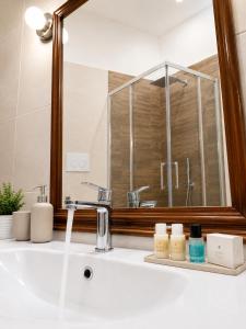 a bathroom with a sink and a mirror at RELAIS TORRE GLORIA in Naples +27 photos