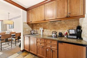 a kitchen with wooden cabinets and a counter top at Remodeled Second Floor Valley View suite no resort fee in Olympic Valley