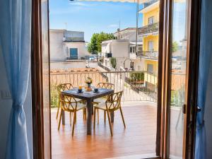 a table and chairs on a balcony with a view at Casa Annalisa in Scauri