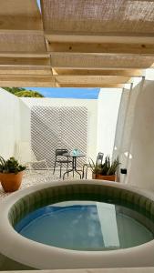 a pool in the middle of a patio with a table at Habita SerpaPinto in Estremoz